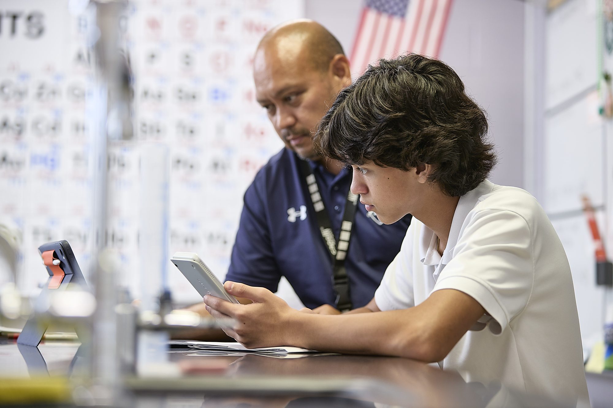 Keswick teacher working with a high school student in science class