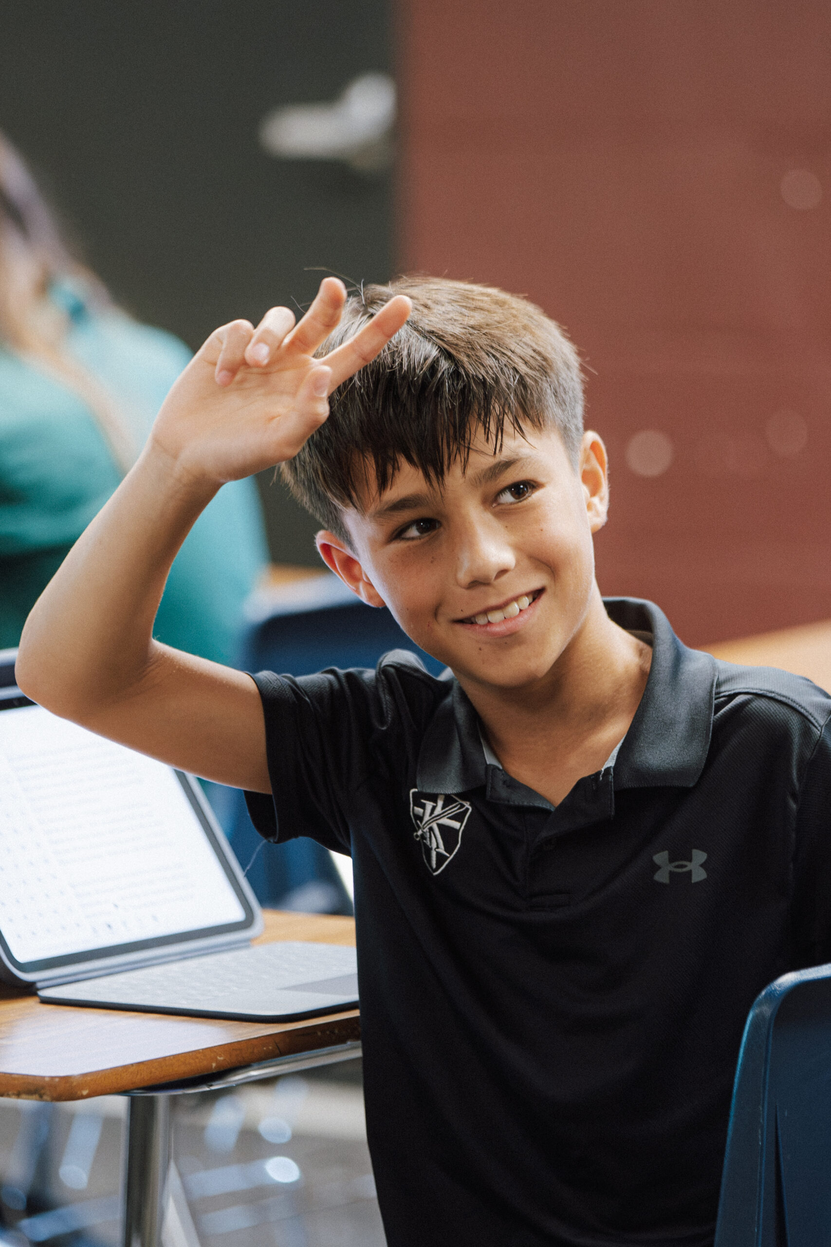 Keswick middle school student raising his hand in class
